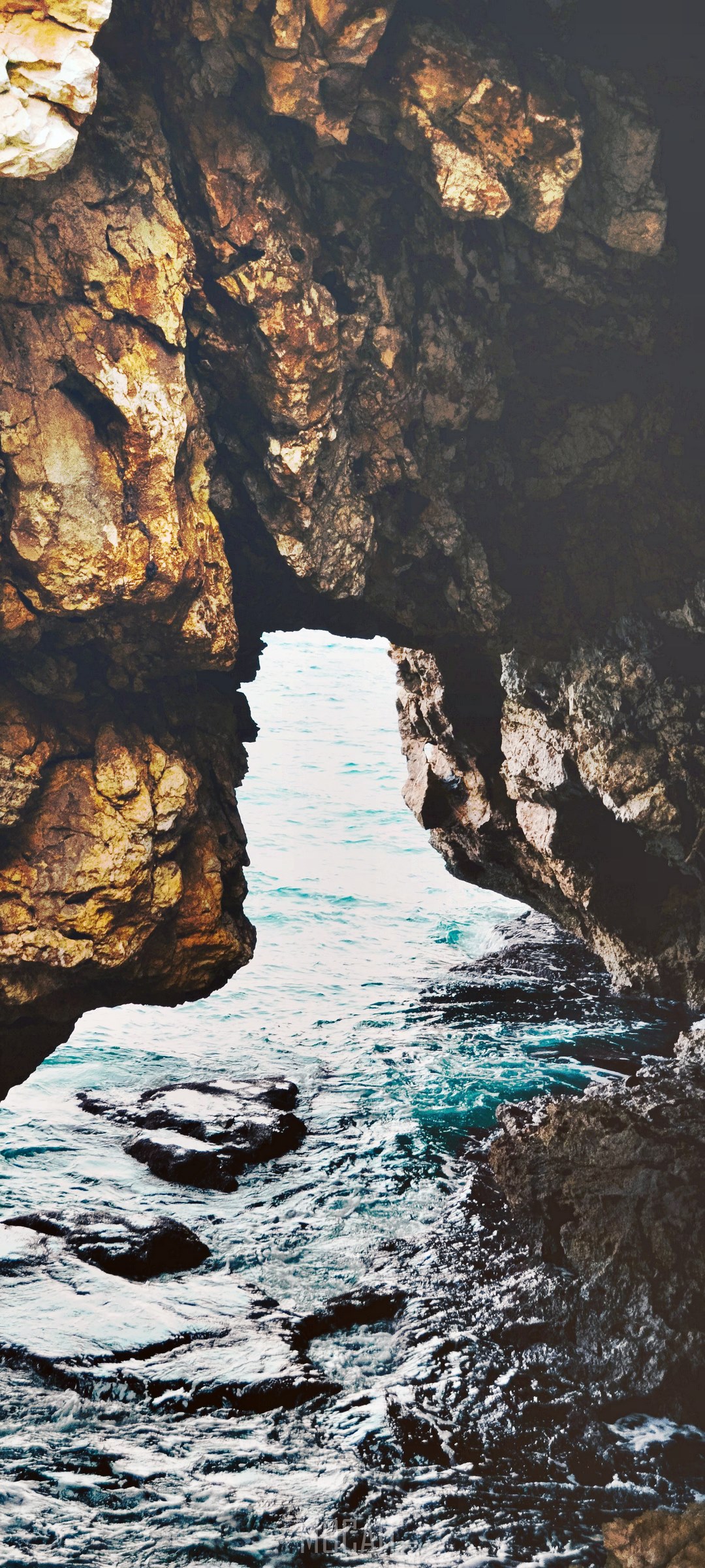 Ocean waves crashing through a rock archway HD Phone Wallpaper