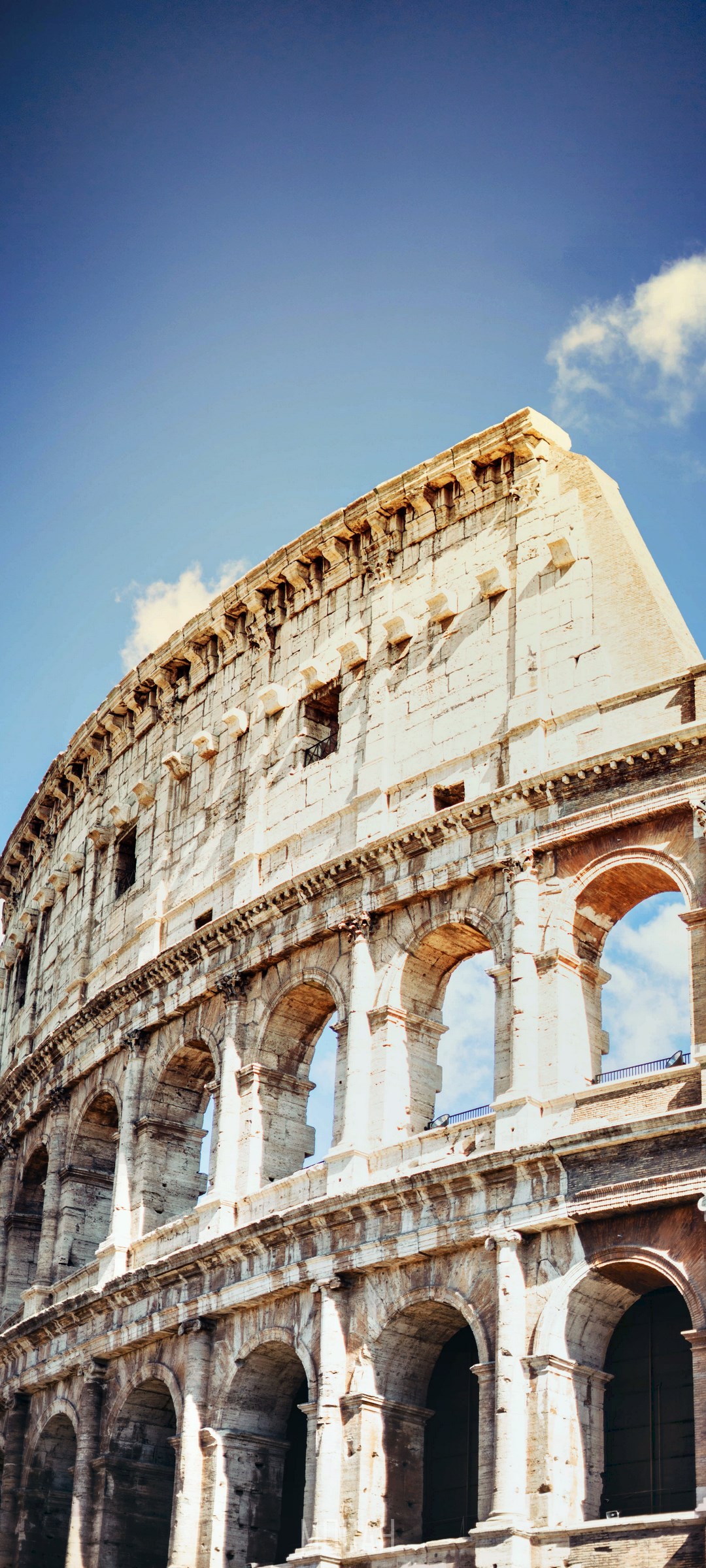 The Colosseum in Rome under a blue sky HD Phone Wallpaper