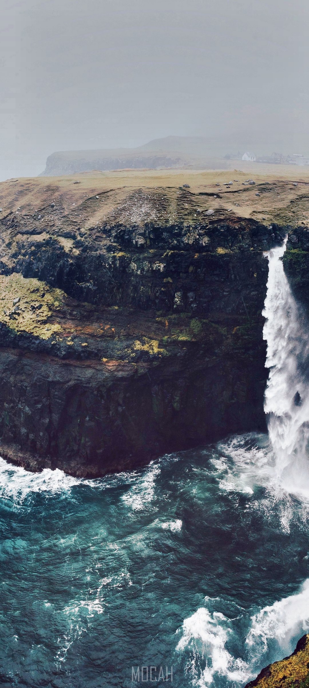 Waterfall cascading into the ocean in the Faroe Islands HD Phone Wallpaper