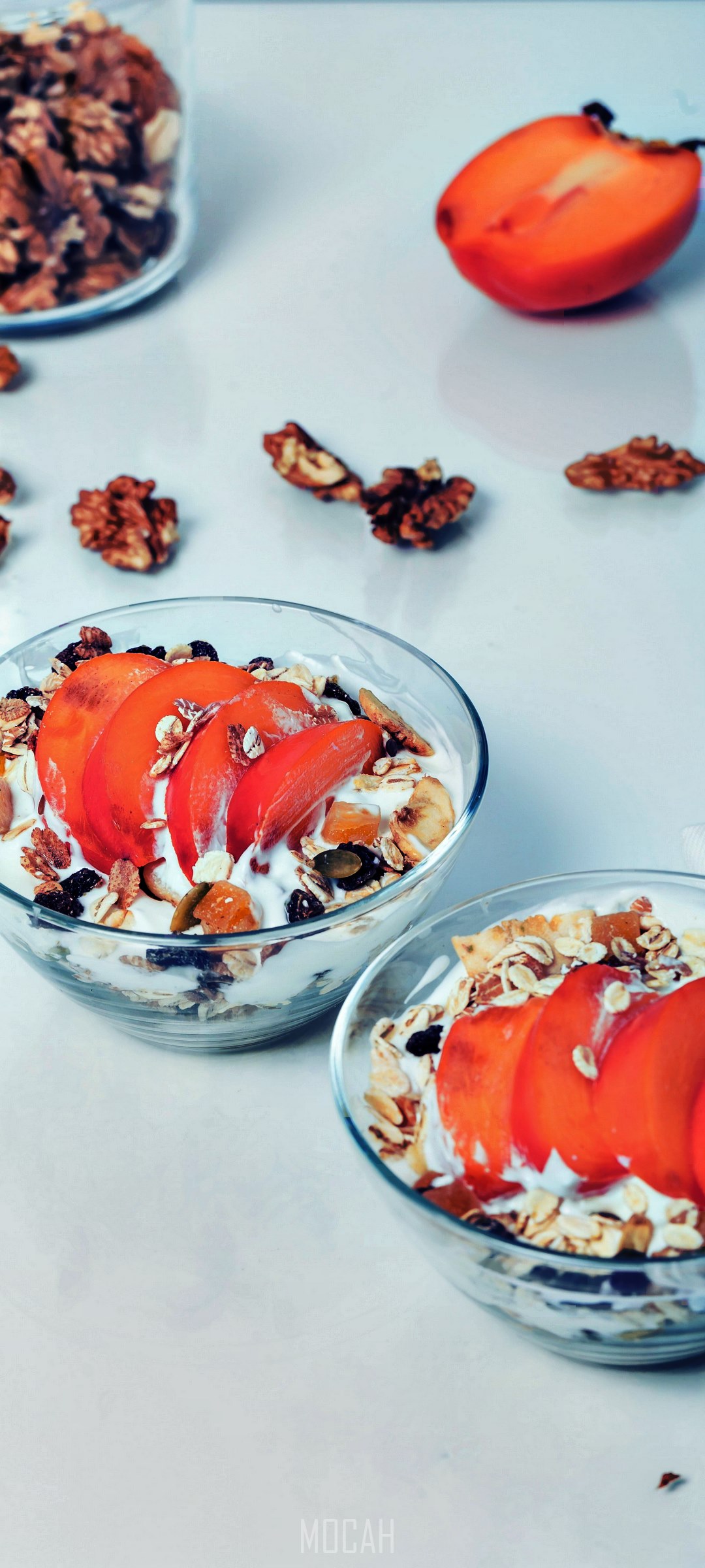 Two bowls of yogurt parfait with persimmon and nuts HD Phone Wallpaper