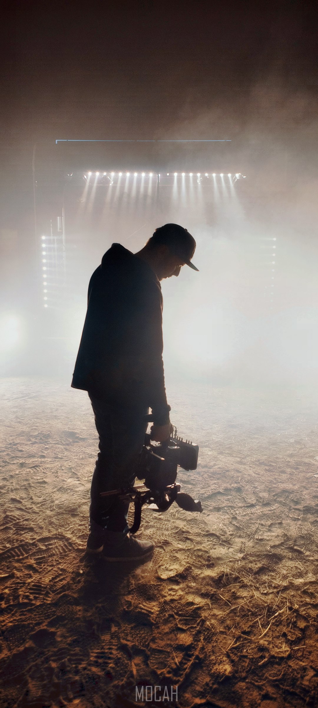 Man with camera in smoke with stage lights HD Phone Wallpaper