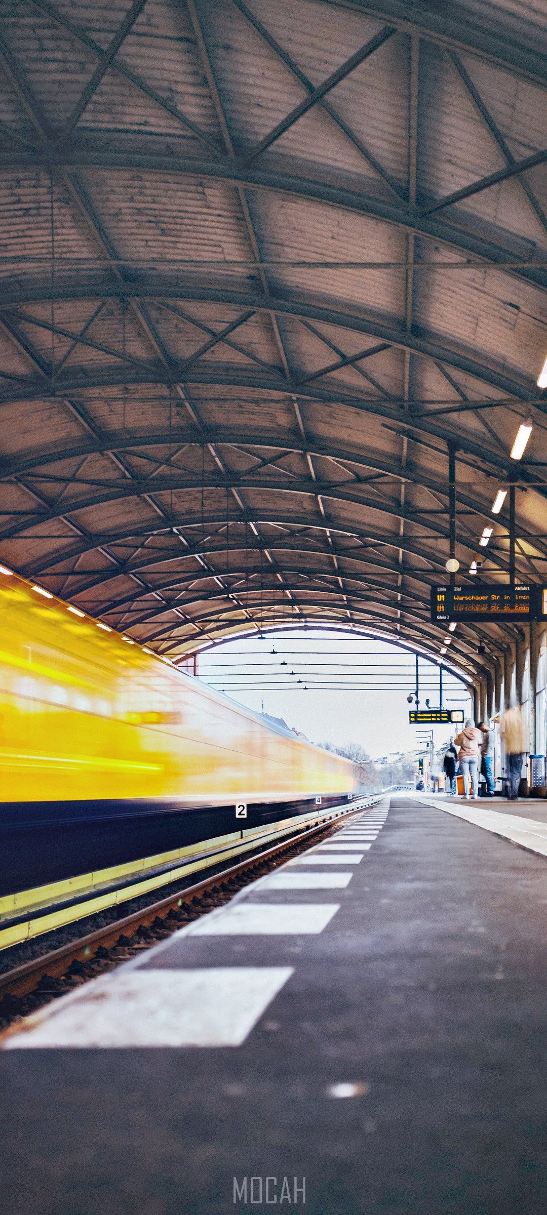 Yellow train at a covered station platform HD Phone Wallpaper