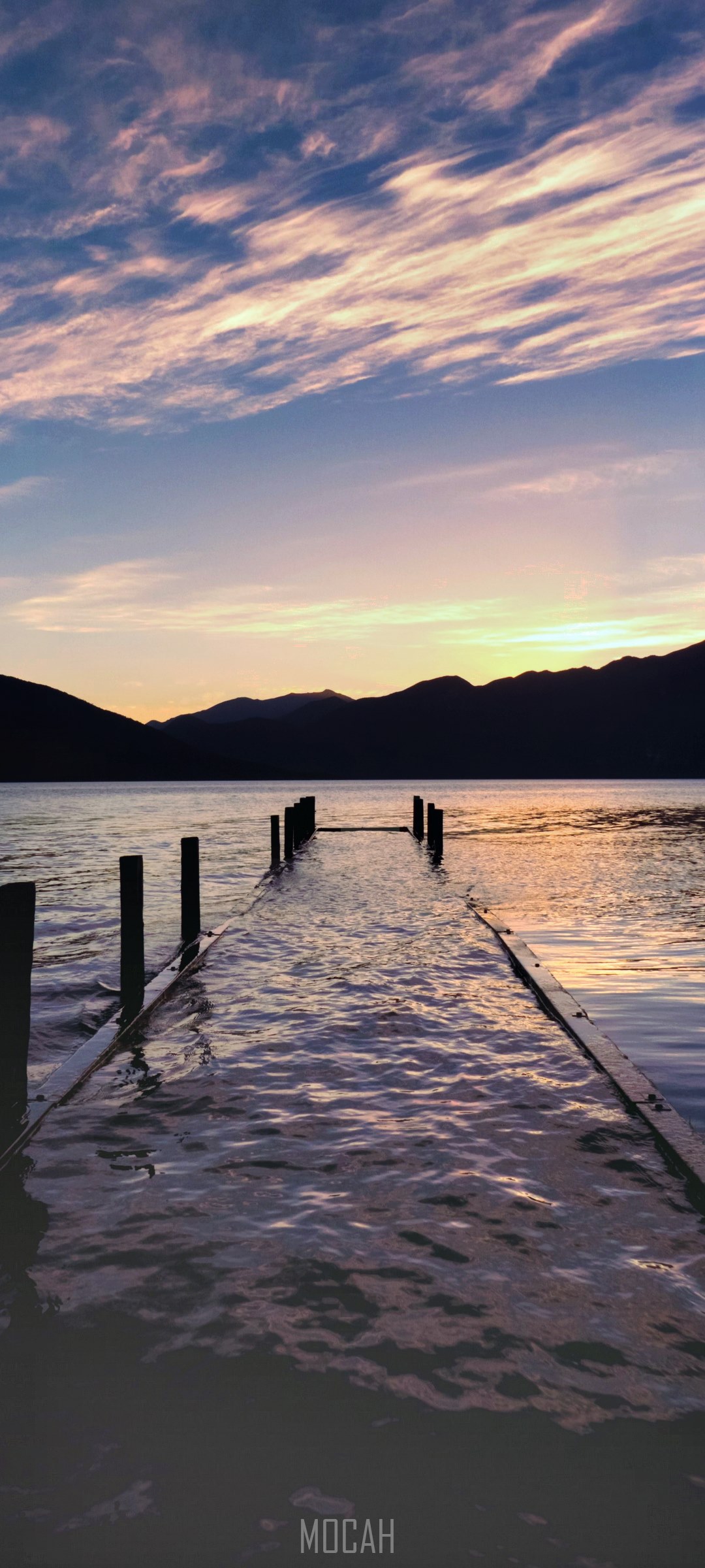 Dock extending into a lake at sunset HD Phone Wallpaper