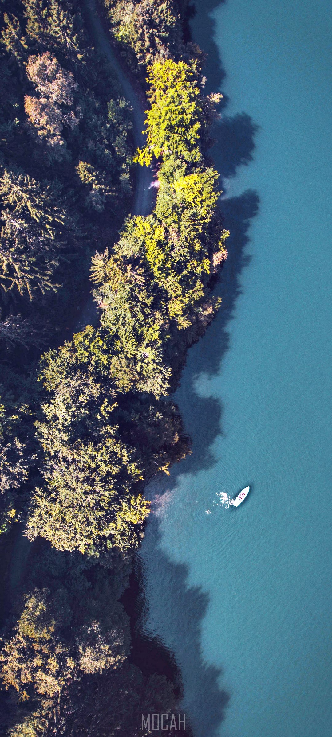 Aerial view of a boat on a lake next to a forest HD Phone Wallpaper