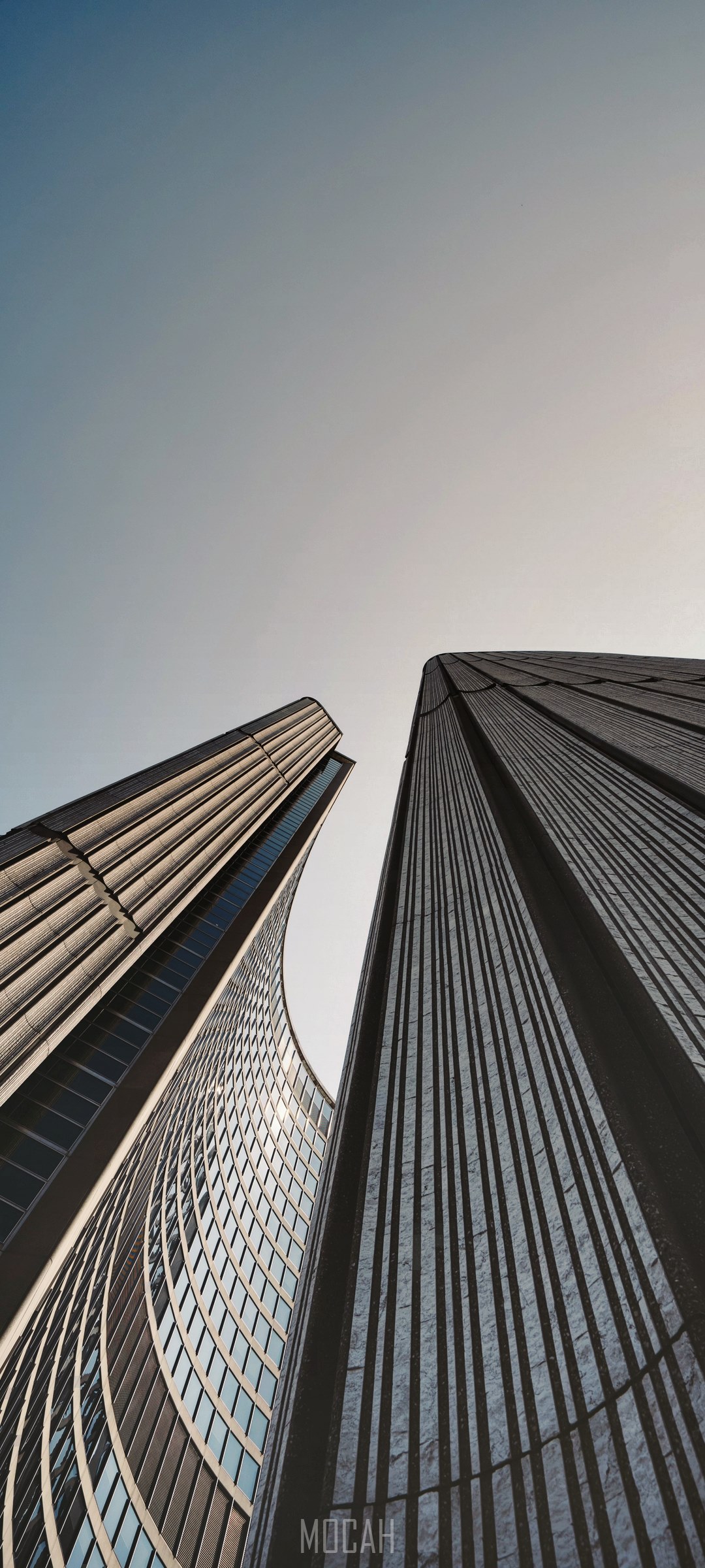 Modern skyscrapers against a clear sky HD Phone Wallpaper