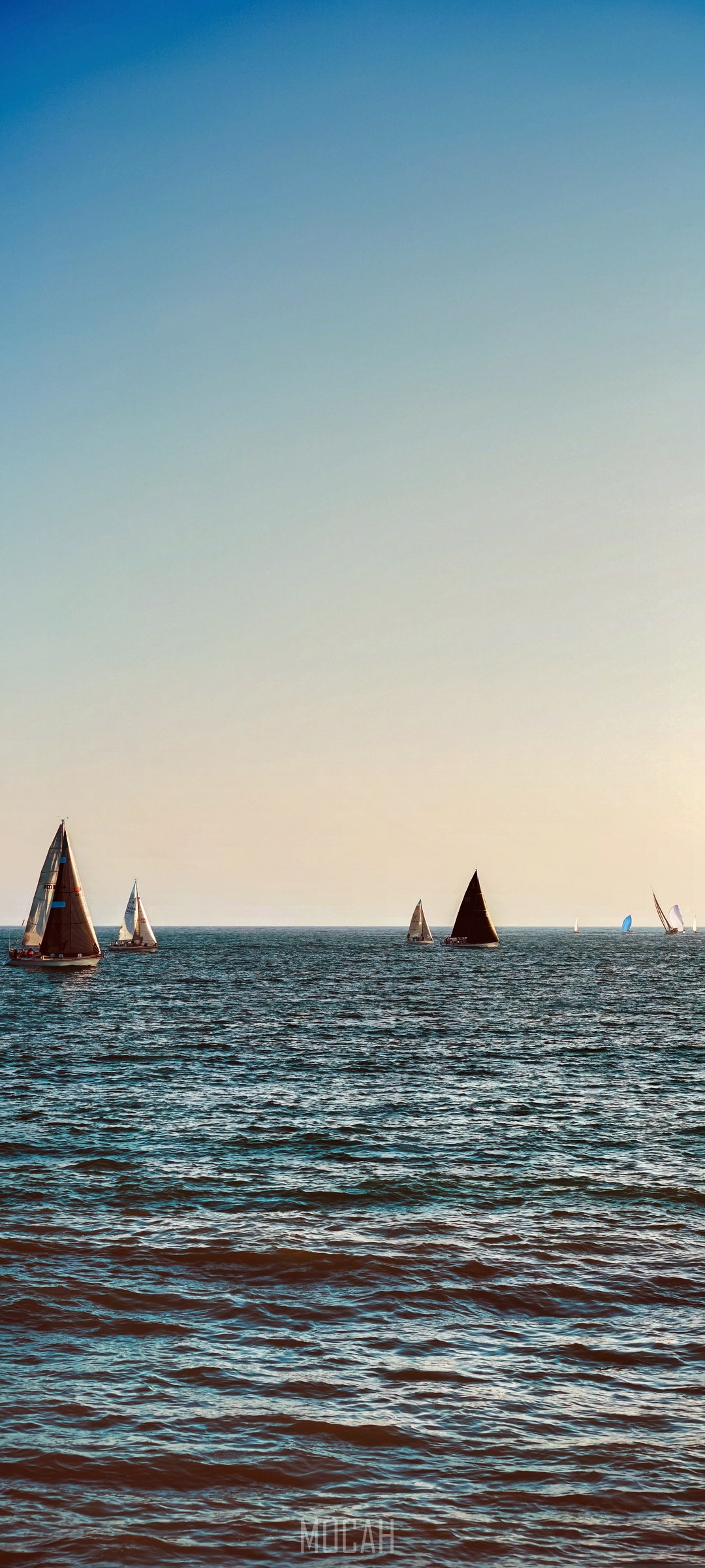 Sailboats on the ocean under a clear sky HD Phone Wallpaper