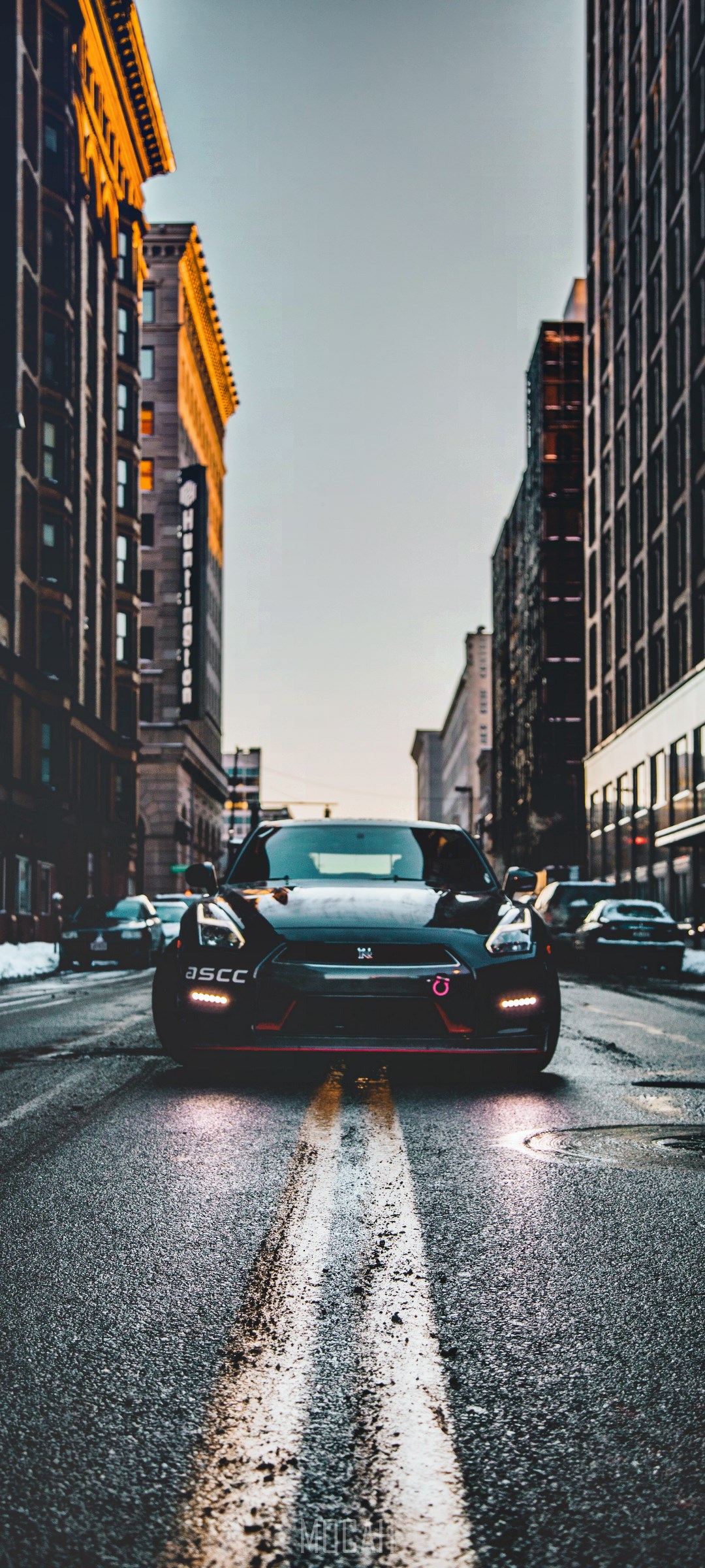 Black Nissan GT-R R35 driving in urban street HD Phone Wallpaper