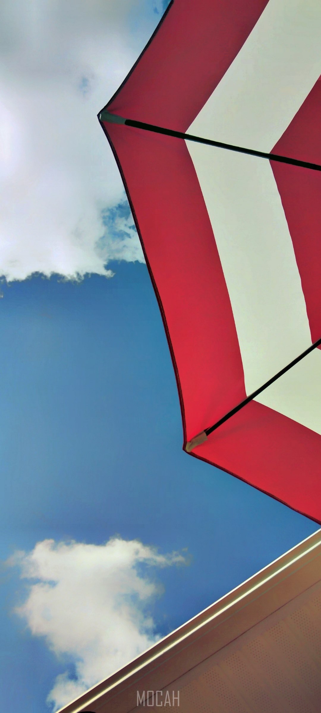 Red and white striped umbrella against blue sky HD Phone Wallpaper