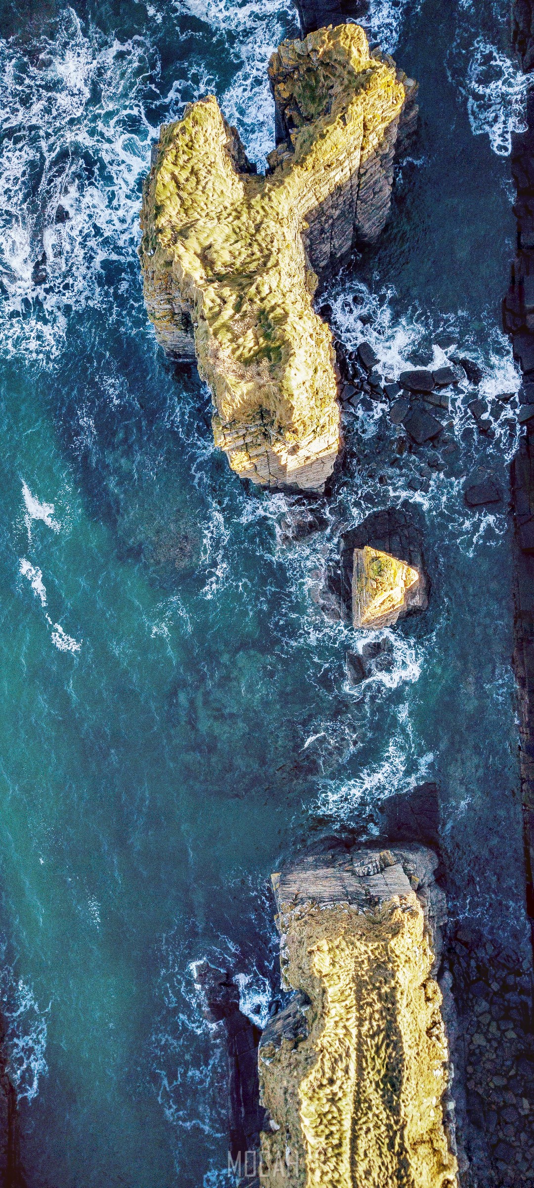Aerial view of rocky sea stacks and ocean waves HD Phone Wallpaper