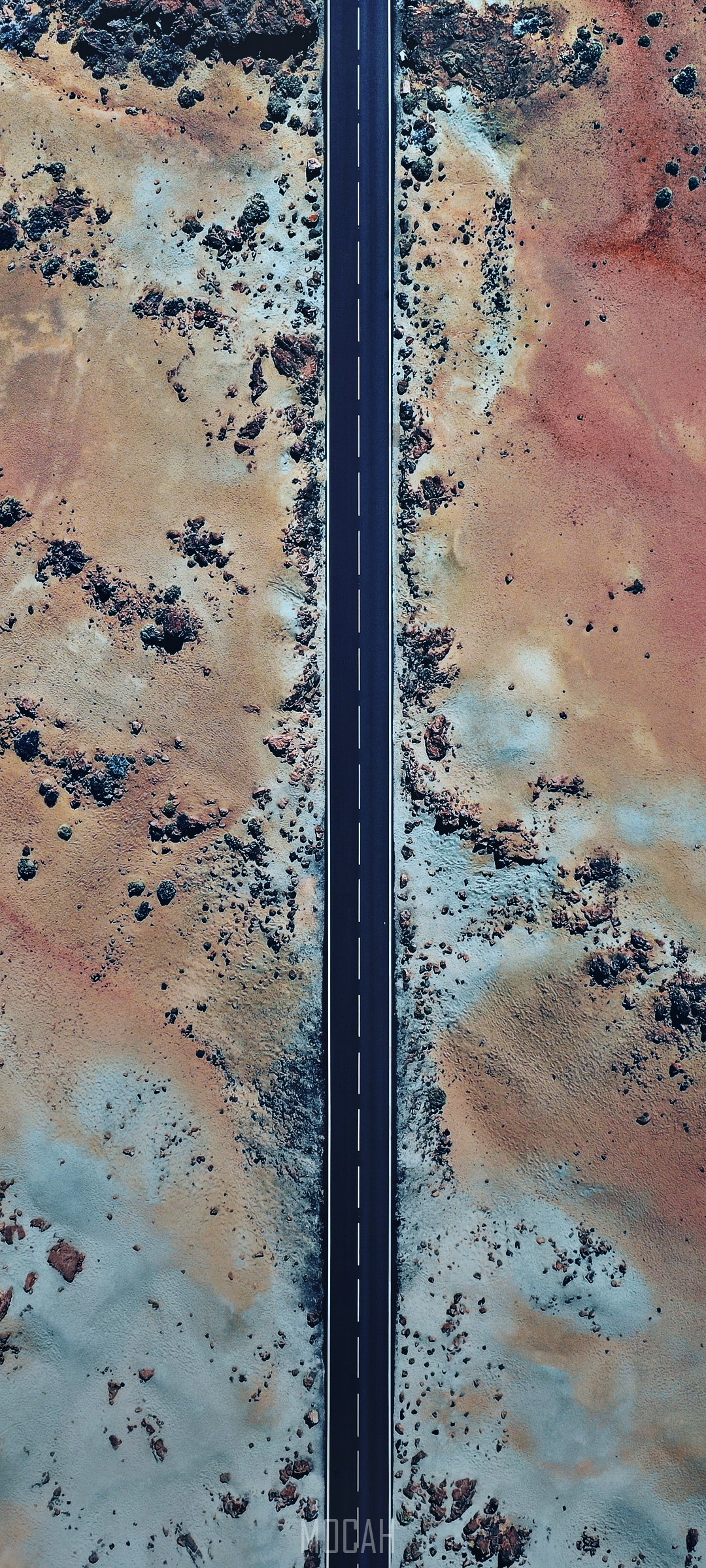 Aerial view of a road through a rocky, colorful landscape HD Phone Wallpaper