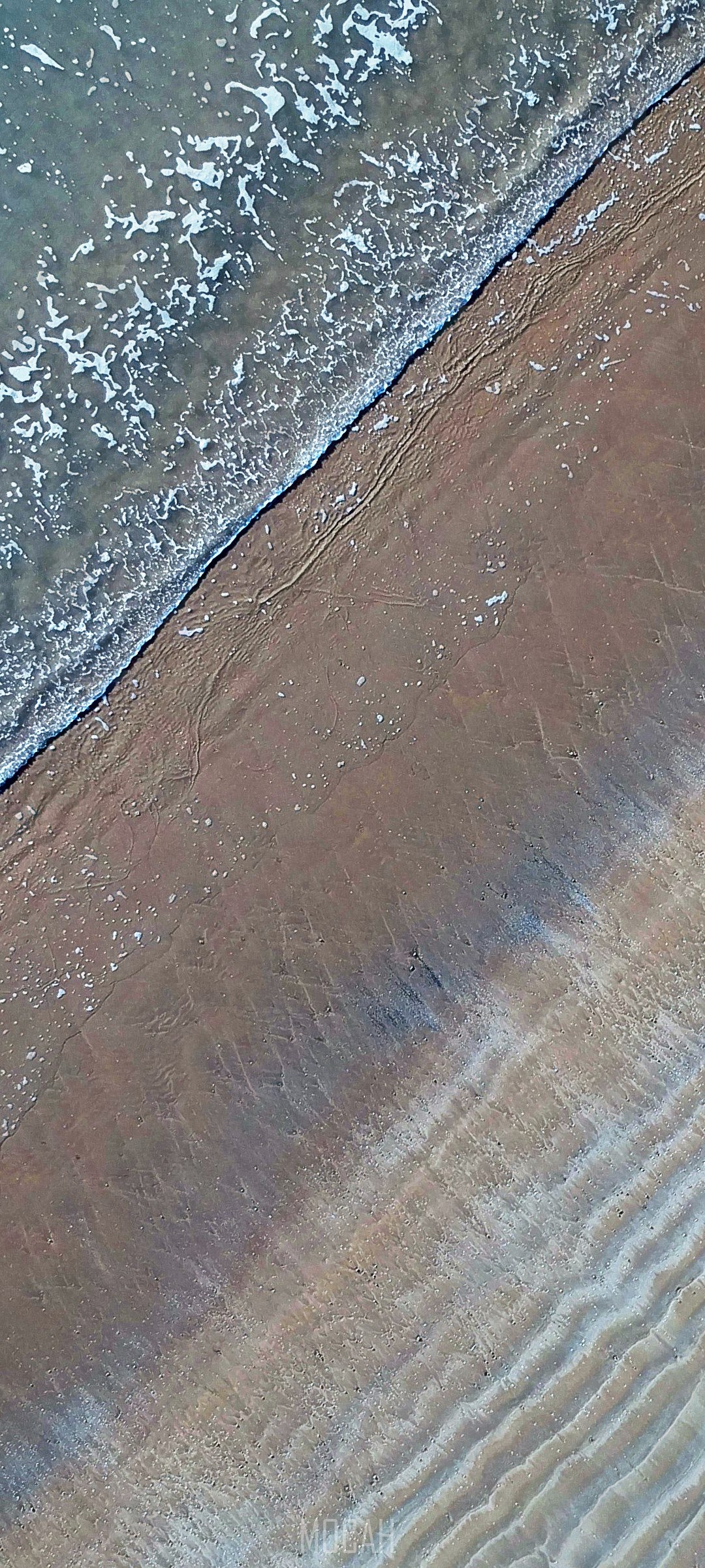 Aerial view of ocean waves on a sandy beach HD Phone Wallpaper
