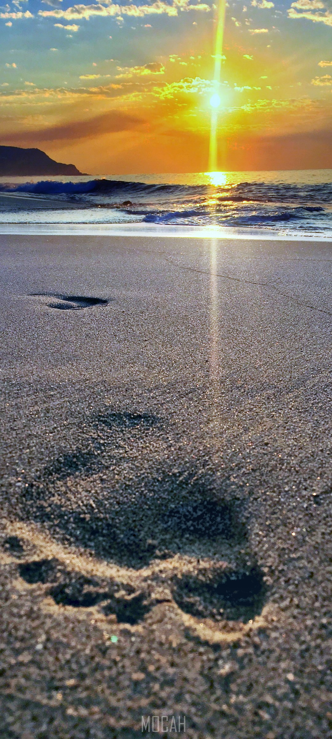 Footprint on a sandy beach at sunset HD Phone Wallpaper