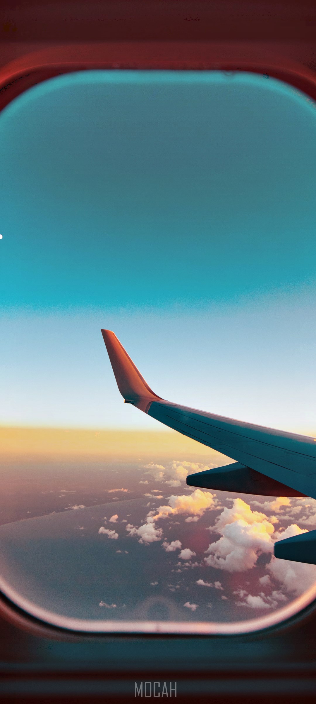 Airplane wing seen through a window at sunset HD Phone Wallpaper