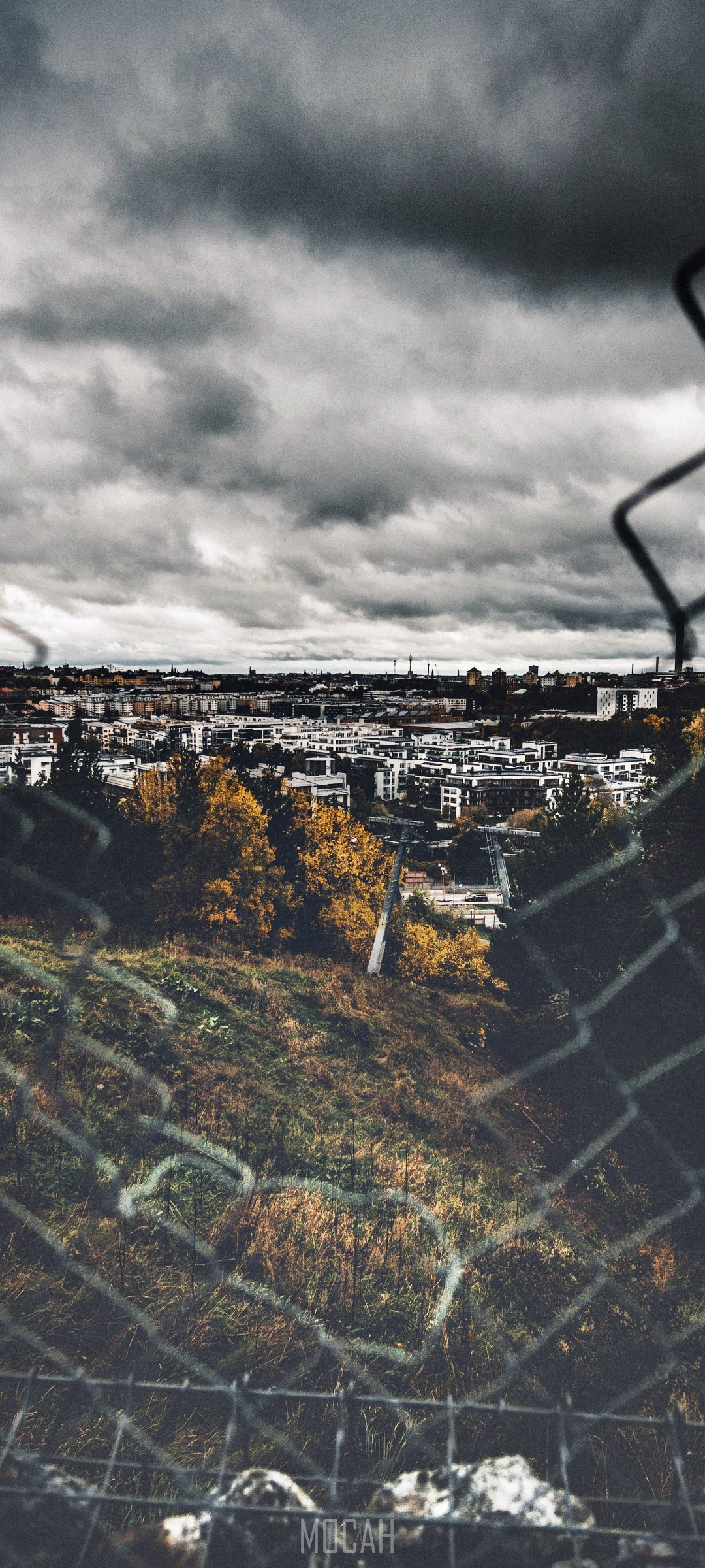 Moody Stockholm cityscape through a fence HD Phone Wallpaper
