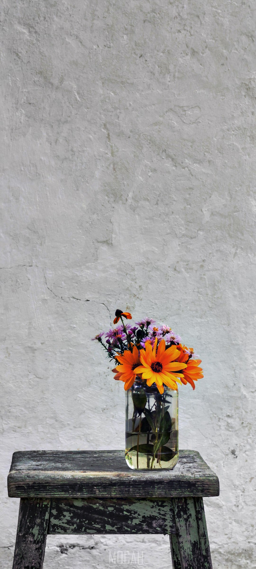 Flowers in a vase on a stool against a wall HD Phone Wallpaper