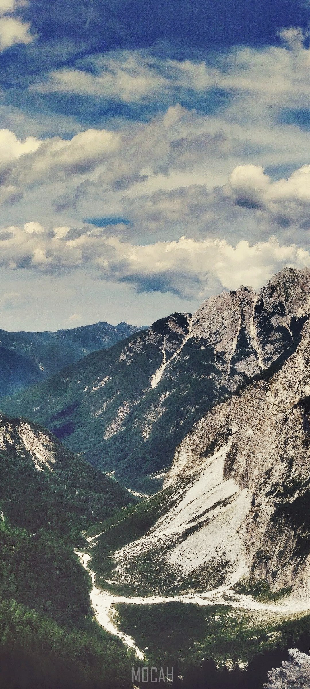 Mountain pass with rugged peaks and clouds HD Phone Wallpaper