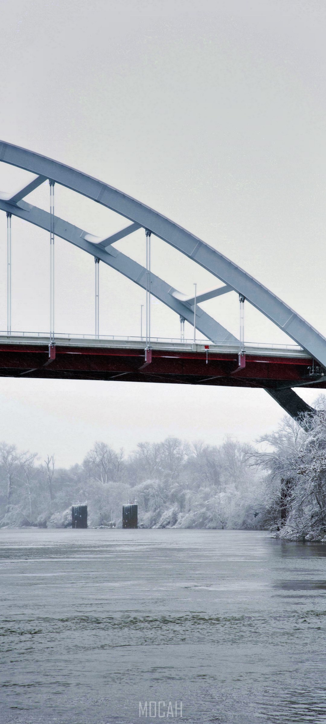 Arch bridge over a frozen river in winter HD Phone Wallpaper