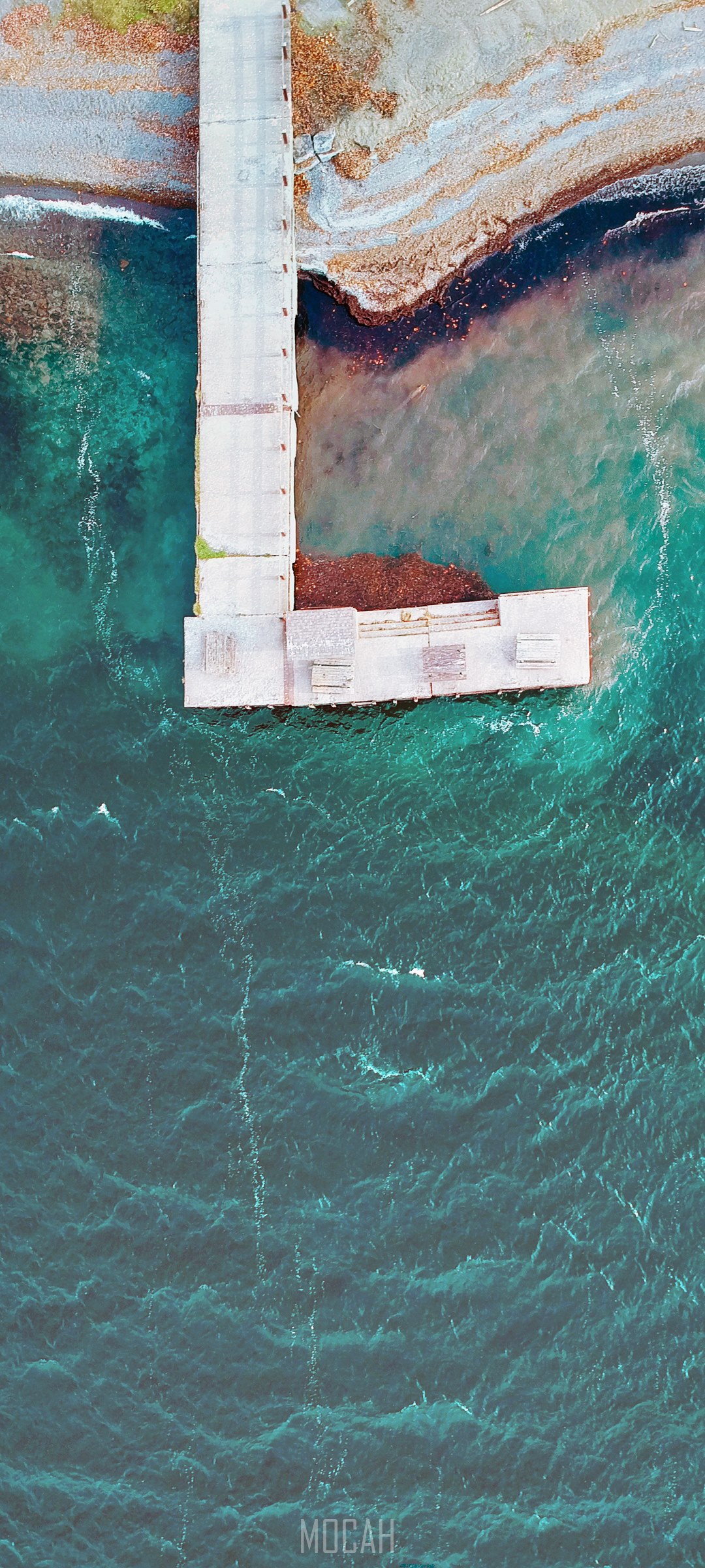 Aerial view of a pier extending into turquoise water HD Phone Wallpaper