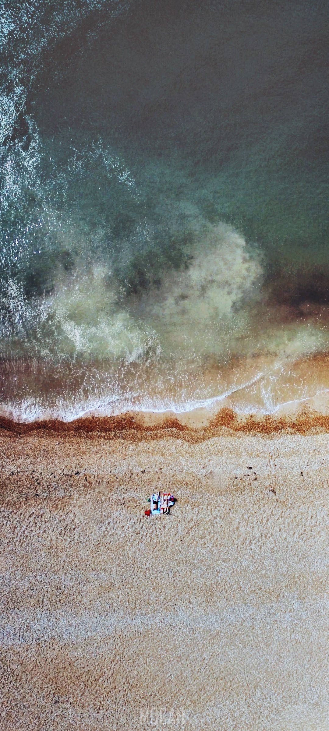 Two people on a beach near the ocean HD Phone Wallpaper