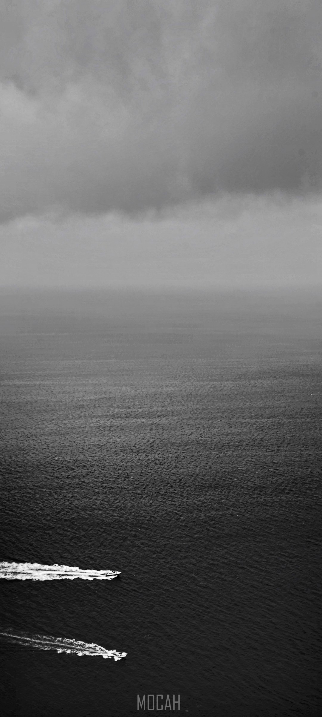 Two boats on the dark sea under a cloudy sky HD Phone Wallpaper