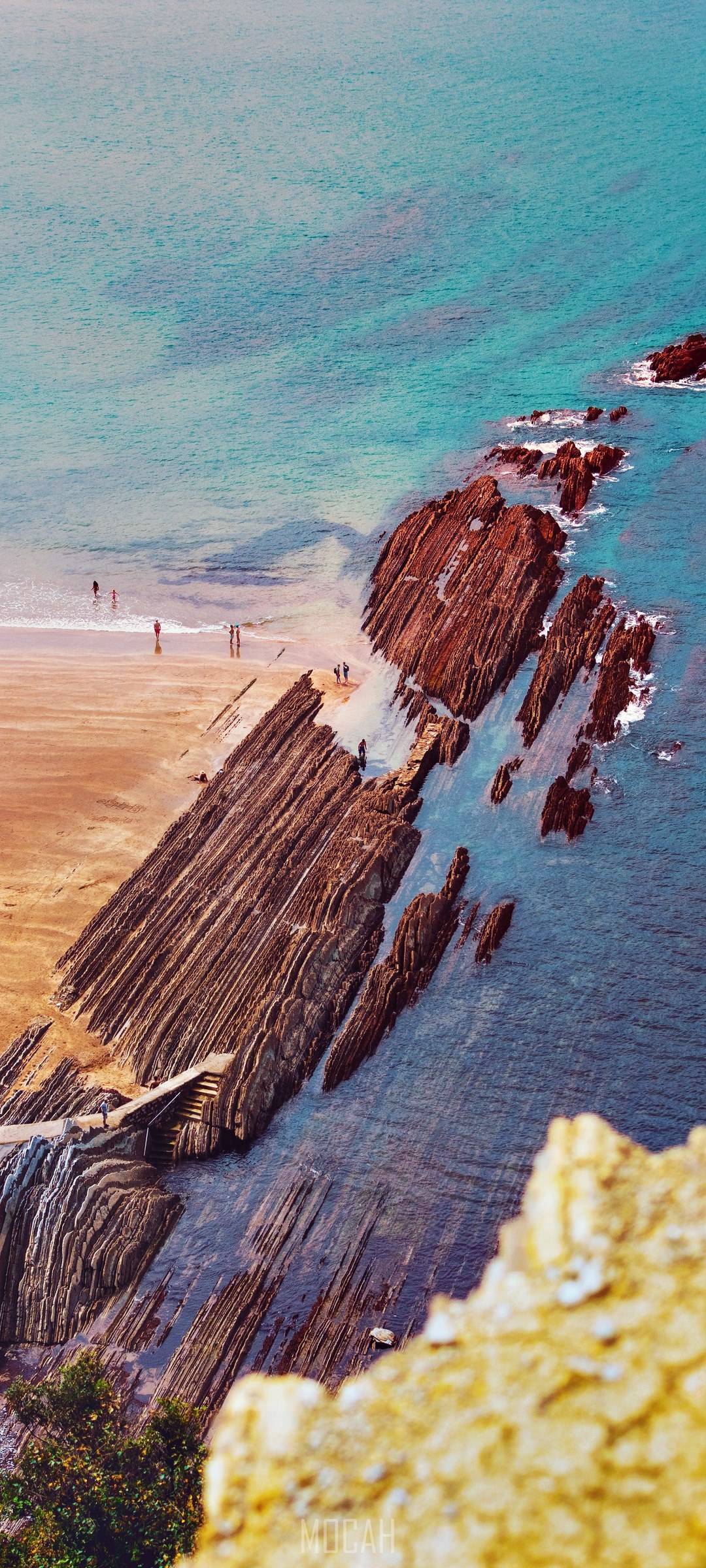 Unique rock formations leading to the ocean at Izturun HD Phone Wallpaper
