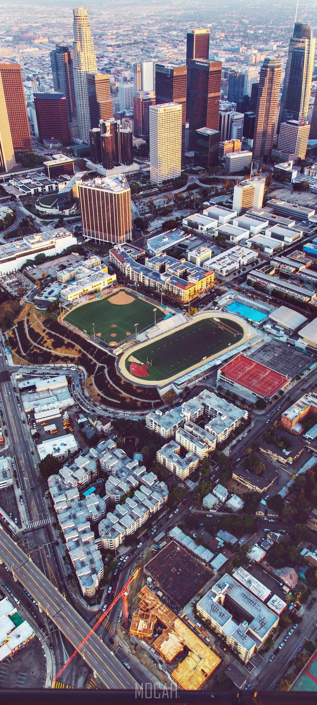 Aerial view of Downtown Los Angeles skyscrapers and sports fields HD Phone Wallpaper