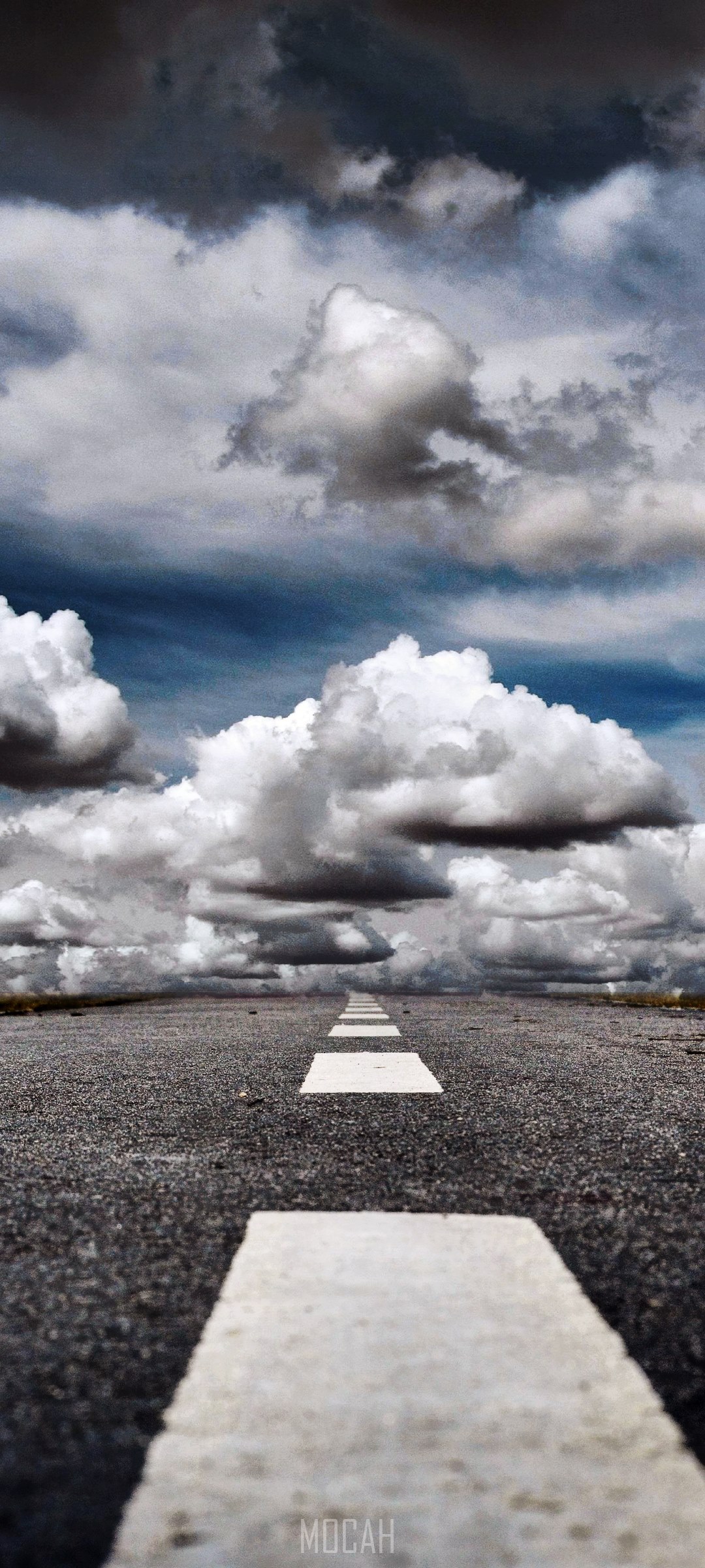Road with white lines and stormy clouds HD Phone Wallpaper