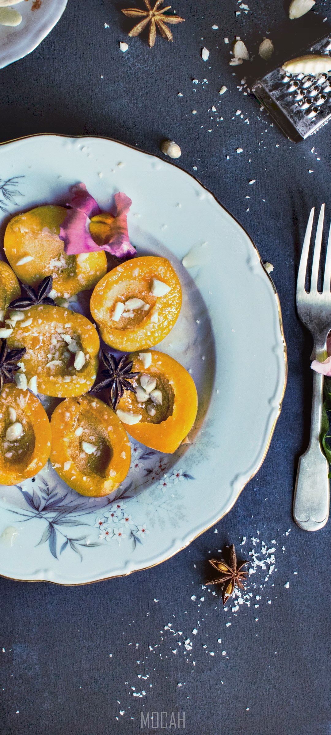 Halved apricots with spices and nuts on a plate HD Phone Wallpaper