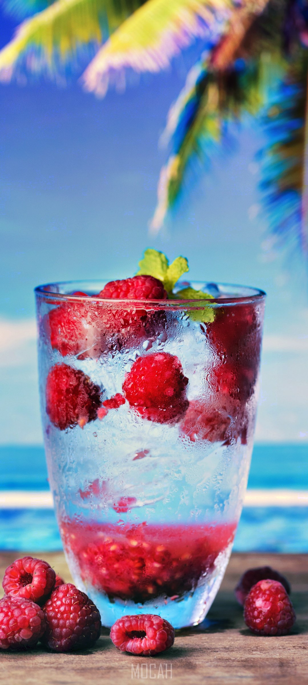 Raspberry drink with ice and mint on a beach background HD Phone Wallpaper