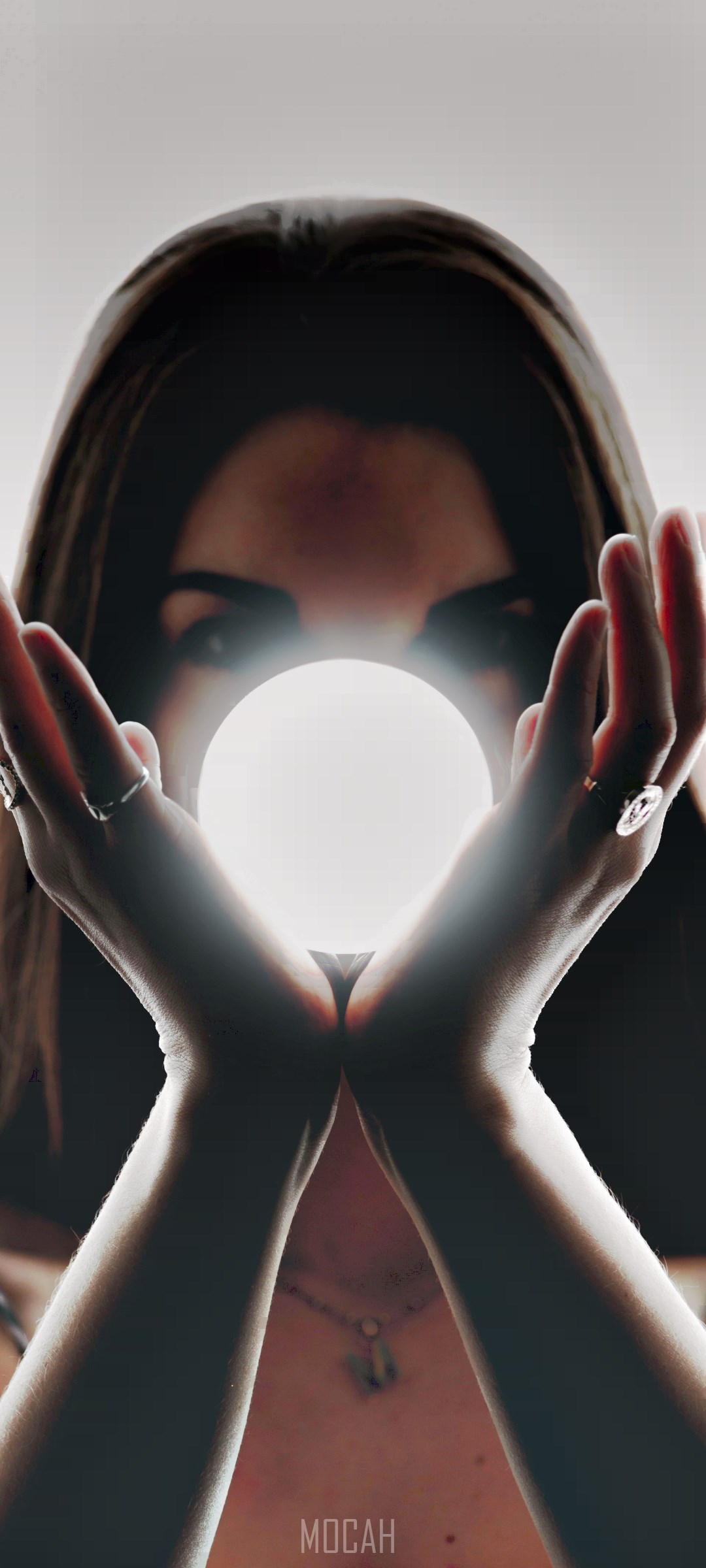 Woman holding a glowing orb HD Phone Wallpaper