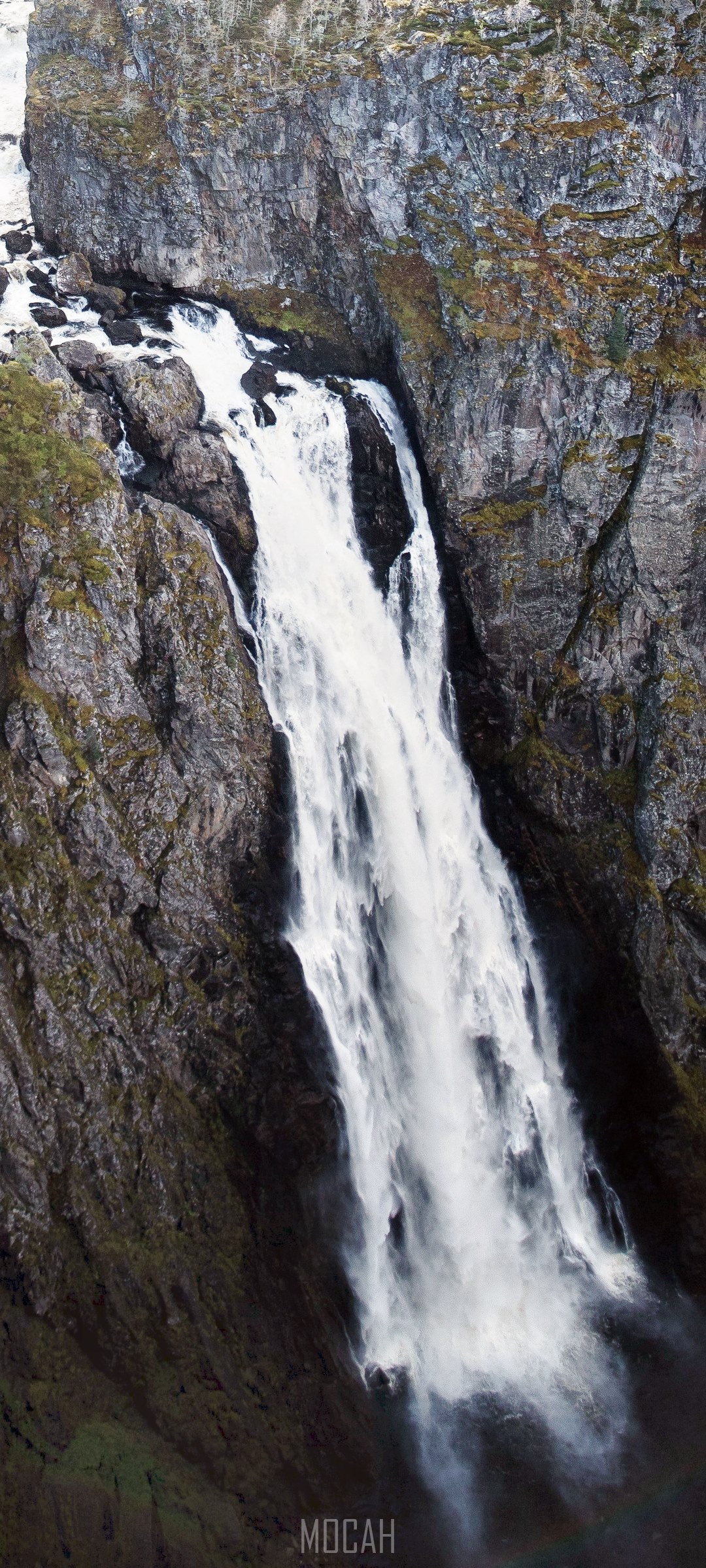 Waterfall cascading down a rocky cliff face HD Phone Wallpaper