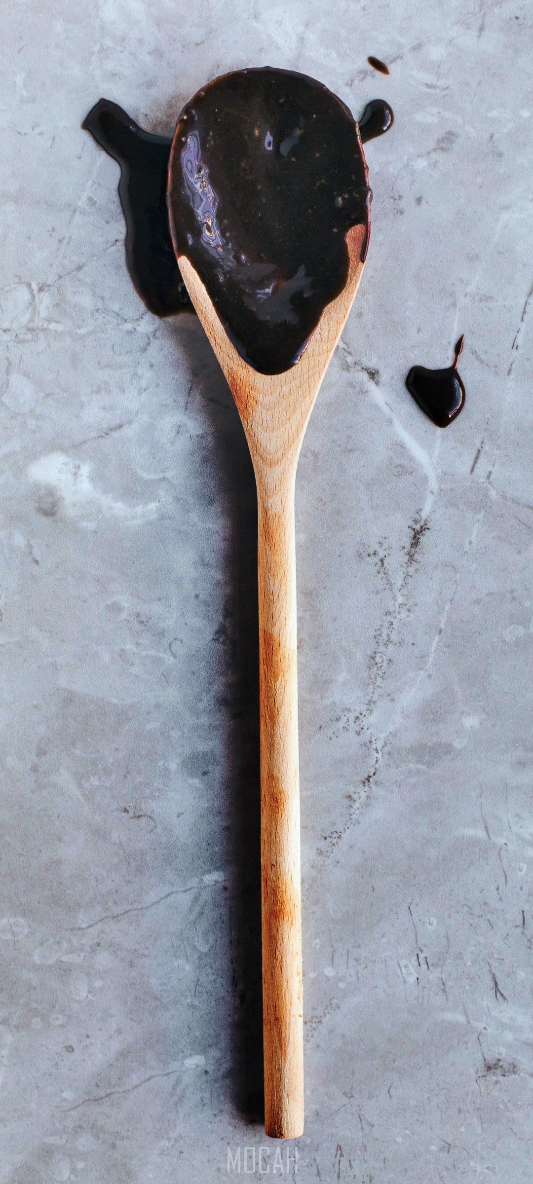 Chocolate sauce on a wooden spoon HD Phone Wallpaper