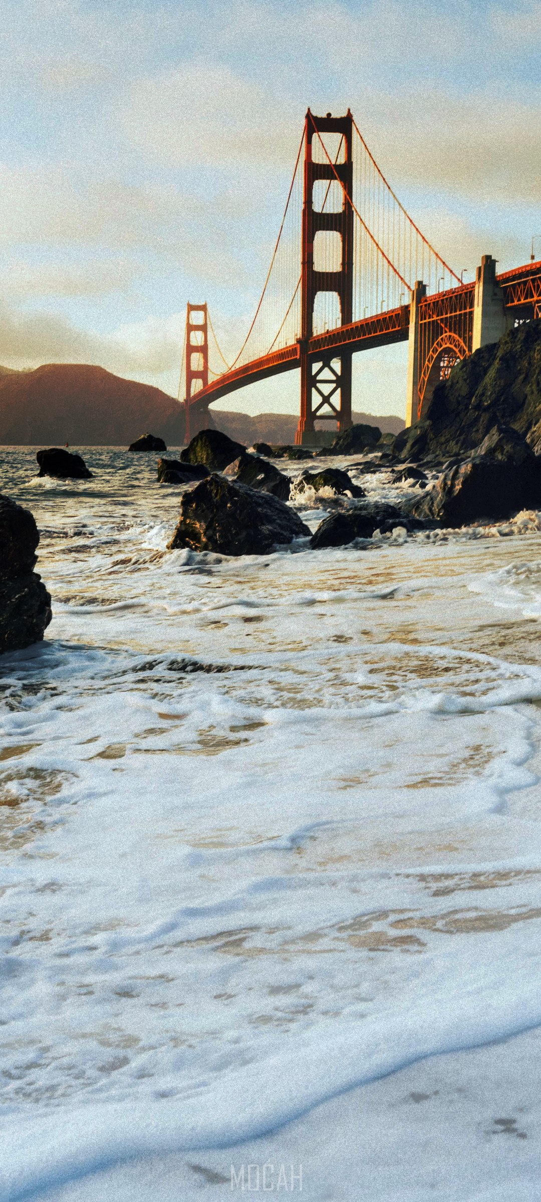 Golden Gate Bridge over the ocean with rocky shore HD Phone Wallpaper