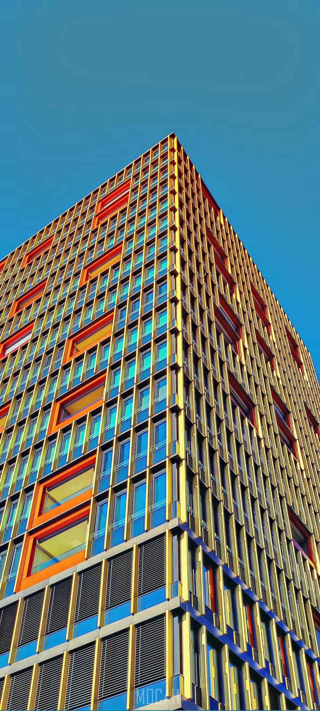 Colorful modern building facade with orange and blue windows HD Phone Wallpaper