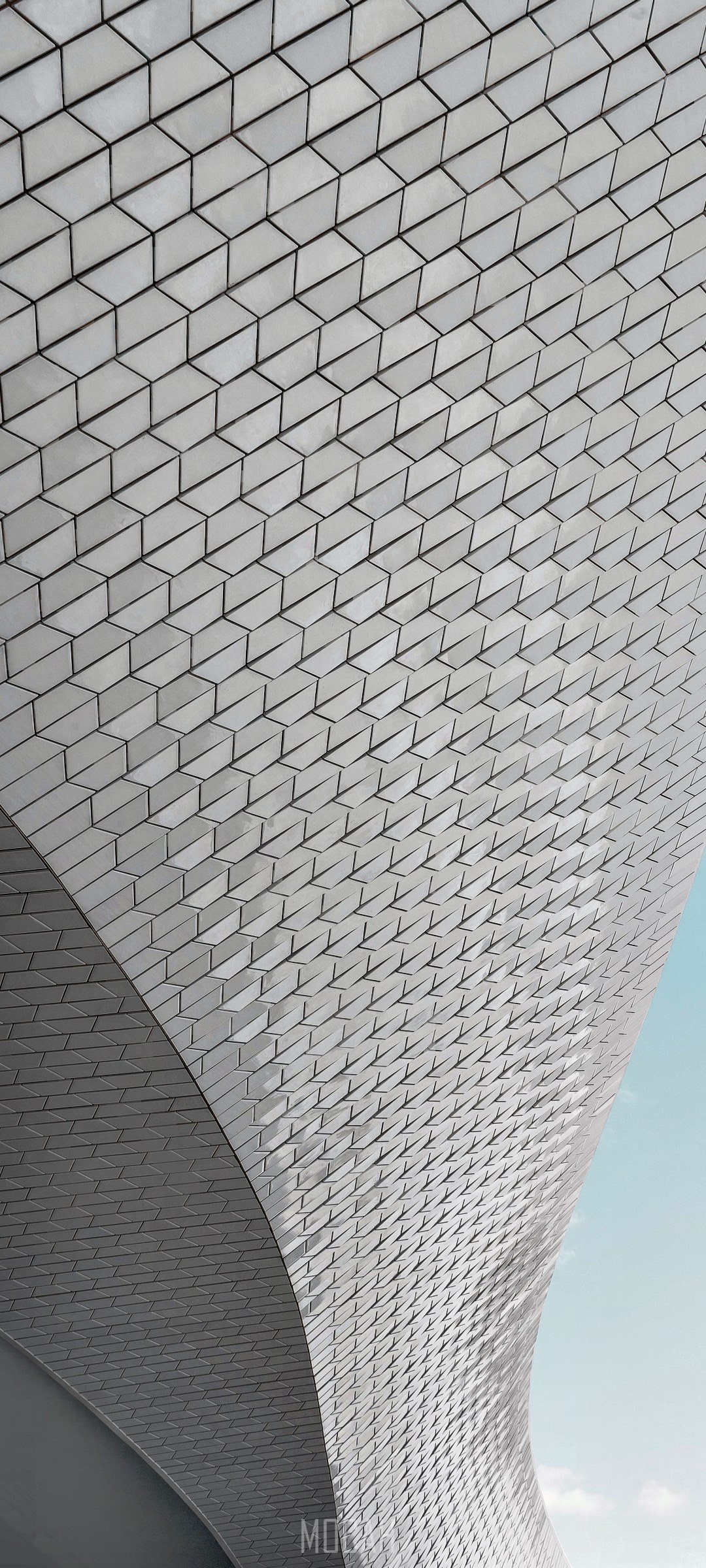 Curving white tiled facade against pale blue sky HD Phone Wallpaper