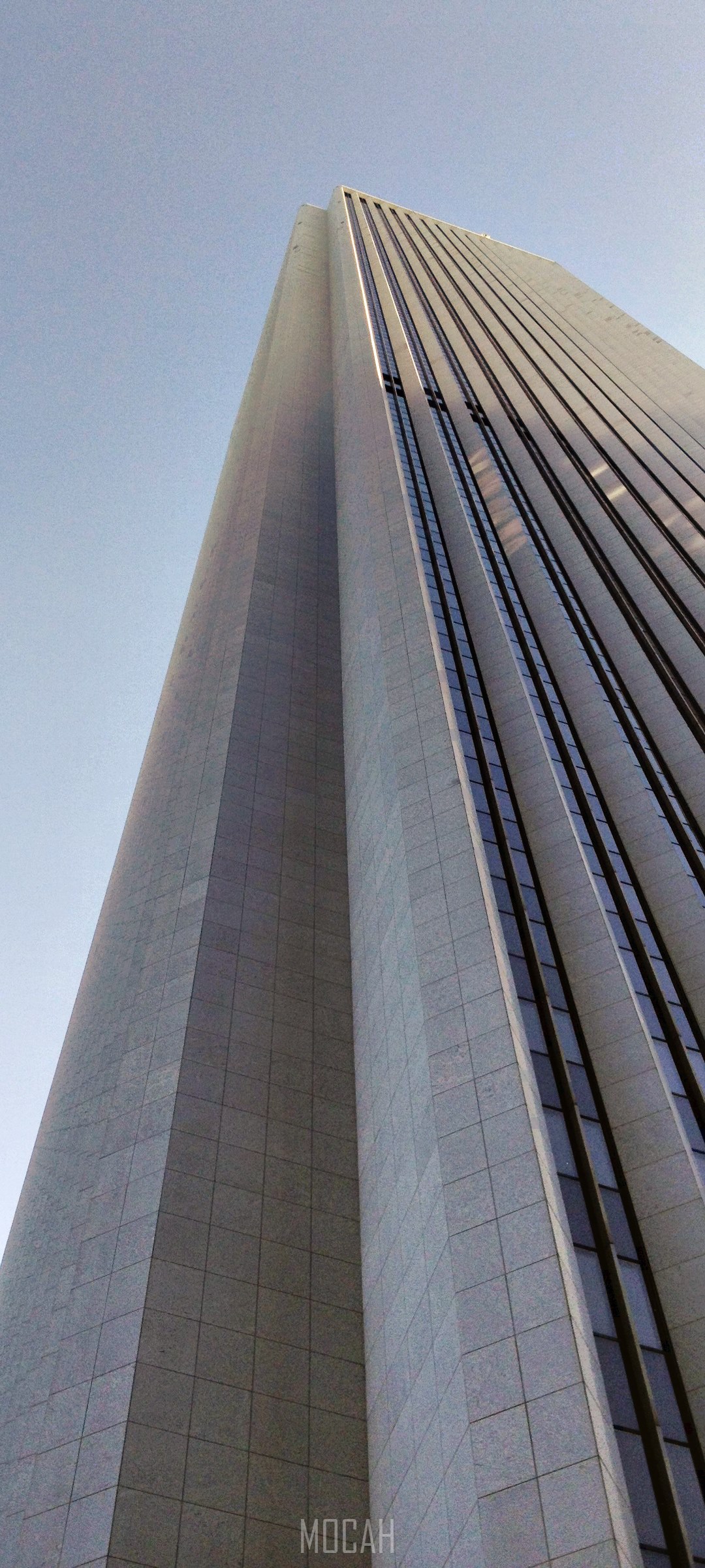 Aon Center skyscraper against a clear blue sky HD Phone Wallpaper