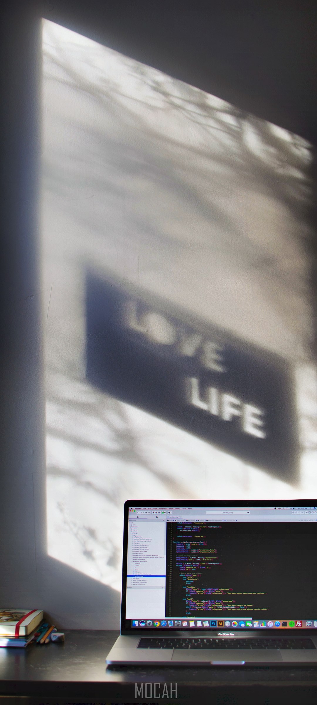 Laptop with code and shadow art on wall HD Phone Wallpaper