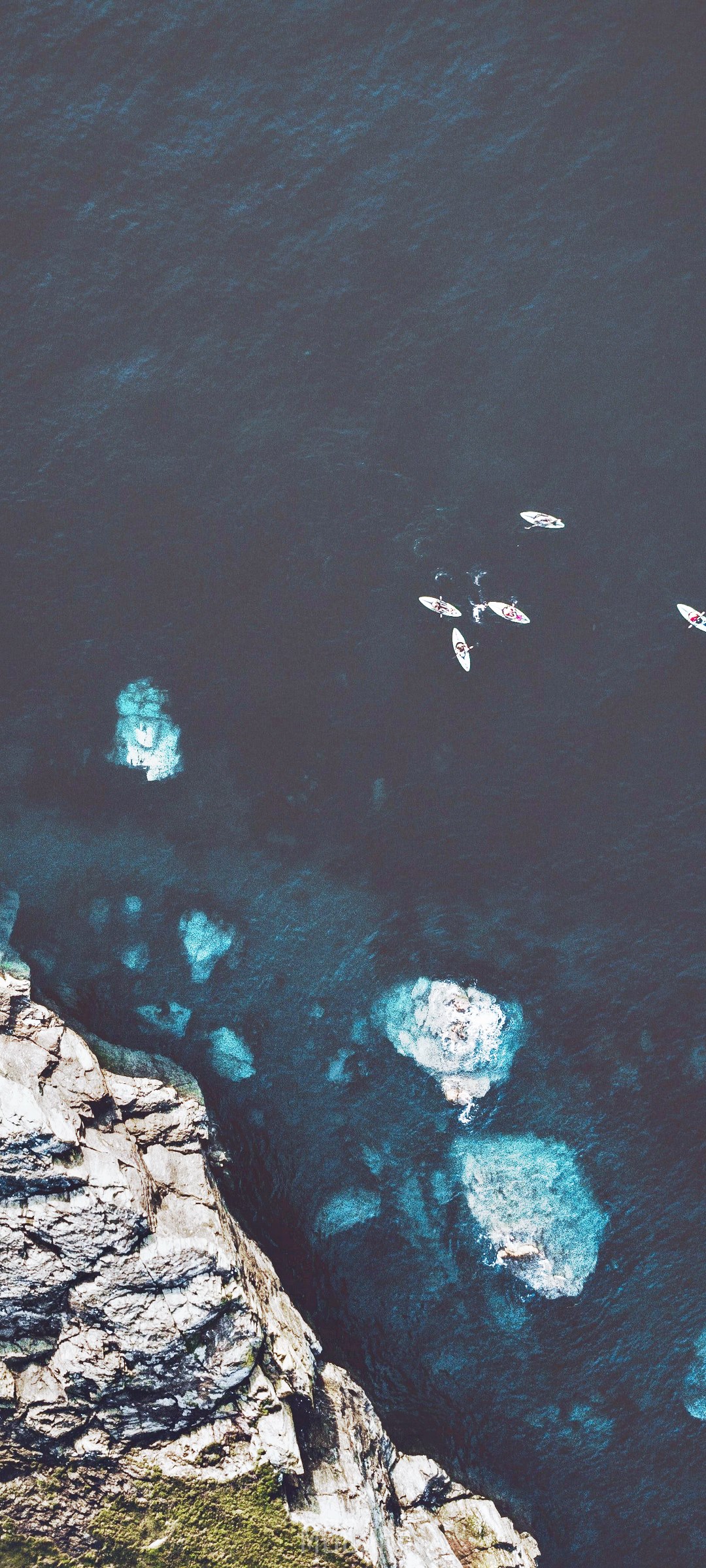 Kayaks on the ocean near rocky cliffs HD Phone Wallpaper