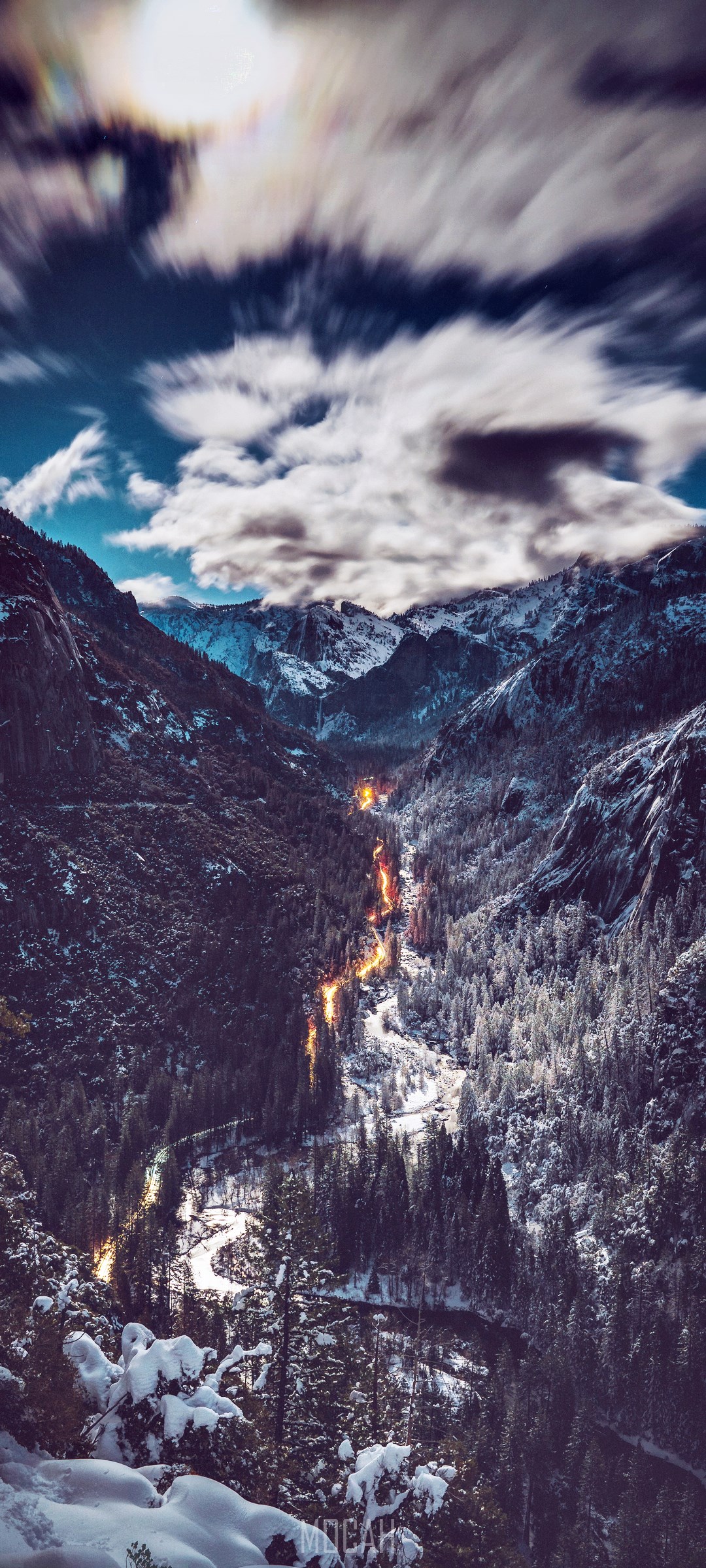 Snowy mountains with a glowing river at dusk HD Phone Wallpaper