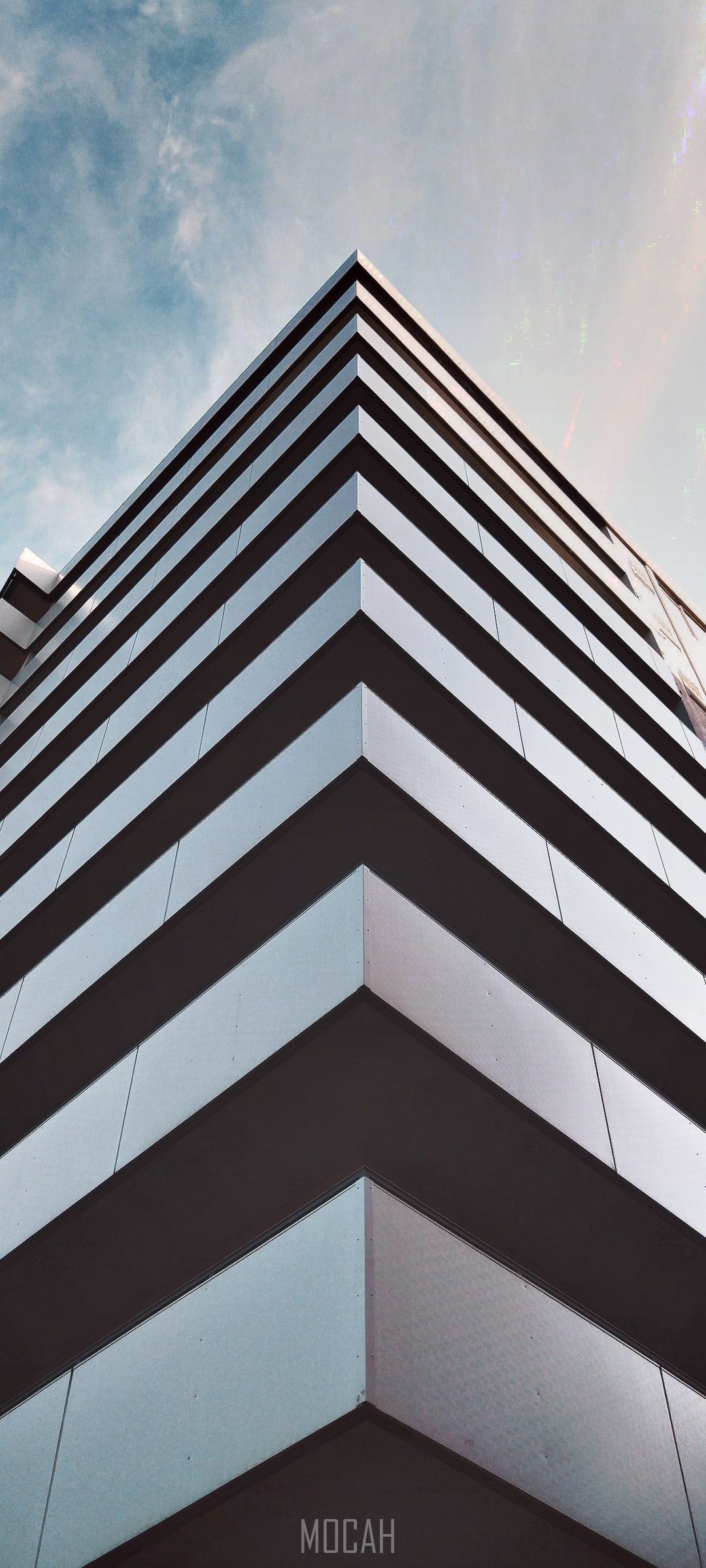 Modern building corner against a cloudy sky HD Phone Wallpaper