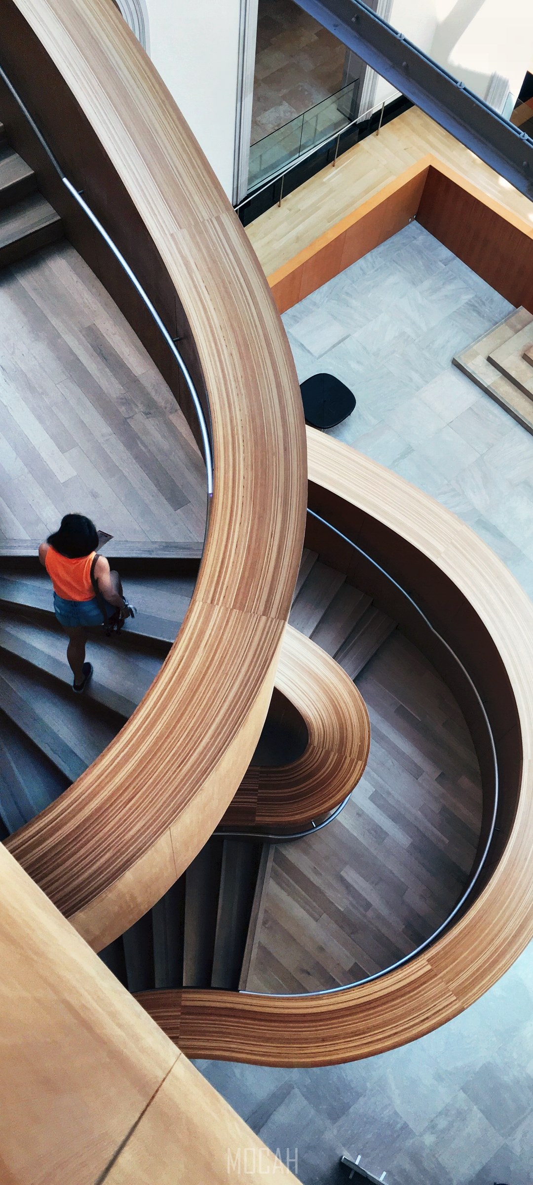 Woman on a modern wooden spiral staircase HD Phone Wallpaper