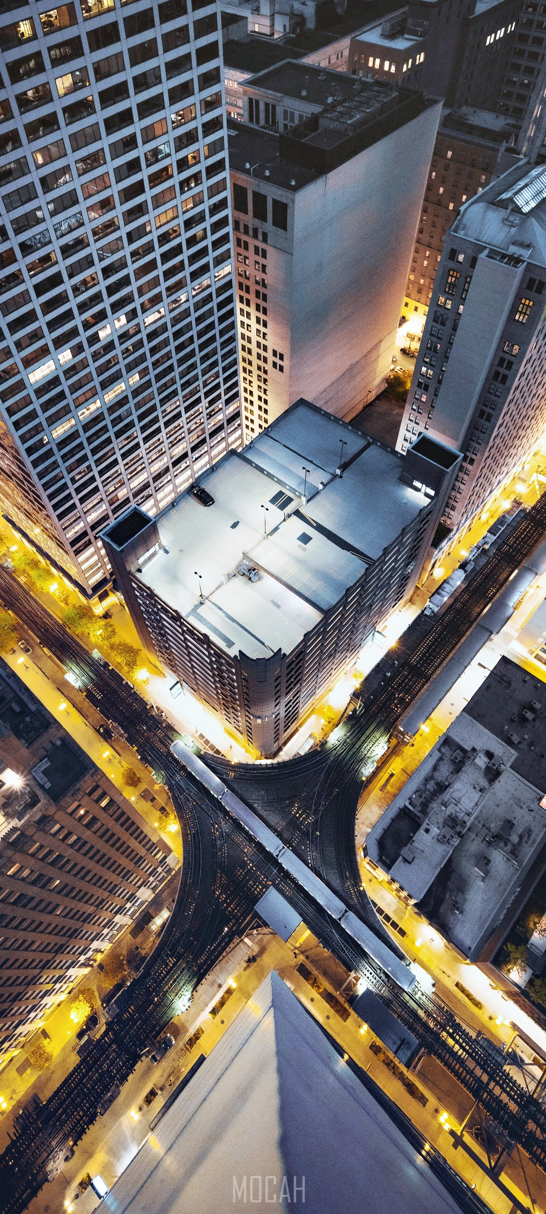 Aerial view of Chicago skyscrapers and train tracks at night HD Phone Wallpaper