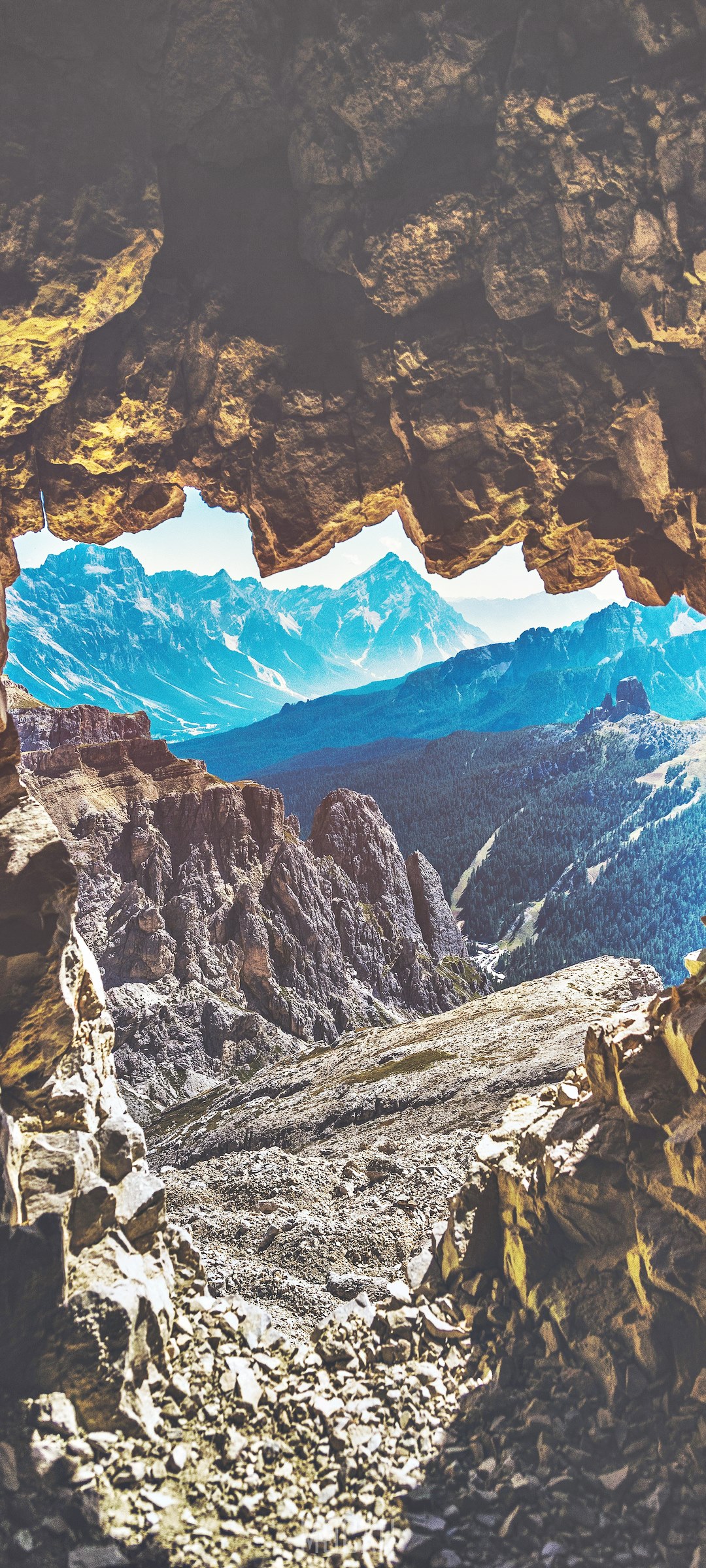 View of mountains through a cave opening HD Phone Wallpaper