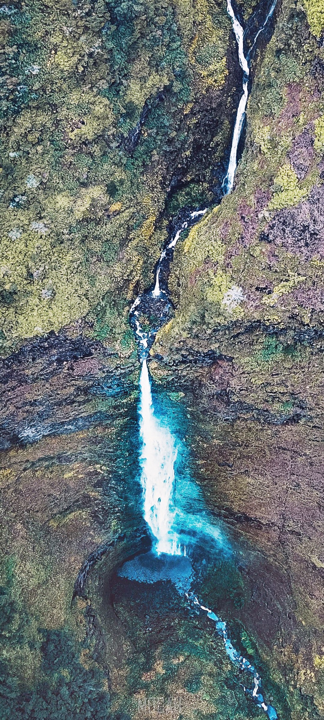 Aerial view of a waterfall cascading down a mossy mountain HD Phone Wallpaper