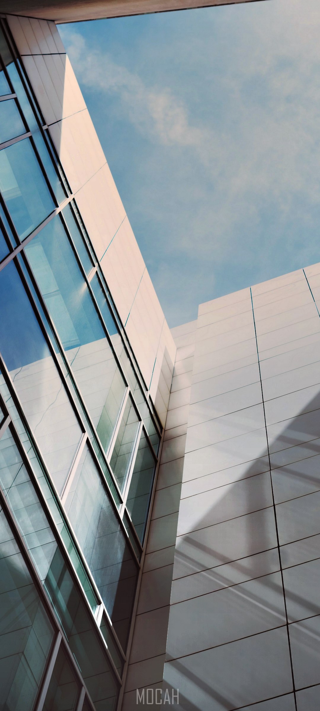 Modern building with glass windows against blue sky HD Phone Wallpaper