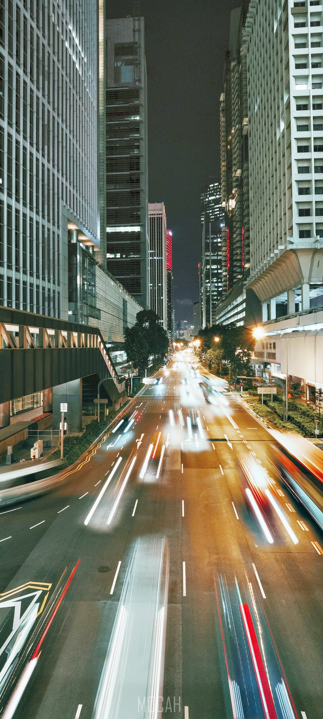City street at night with light trails from cars HD Phone Wallpaper