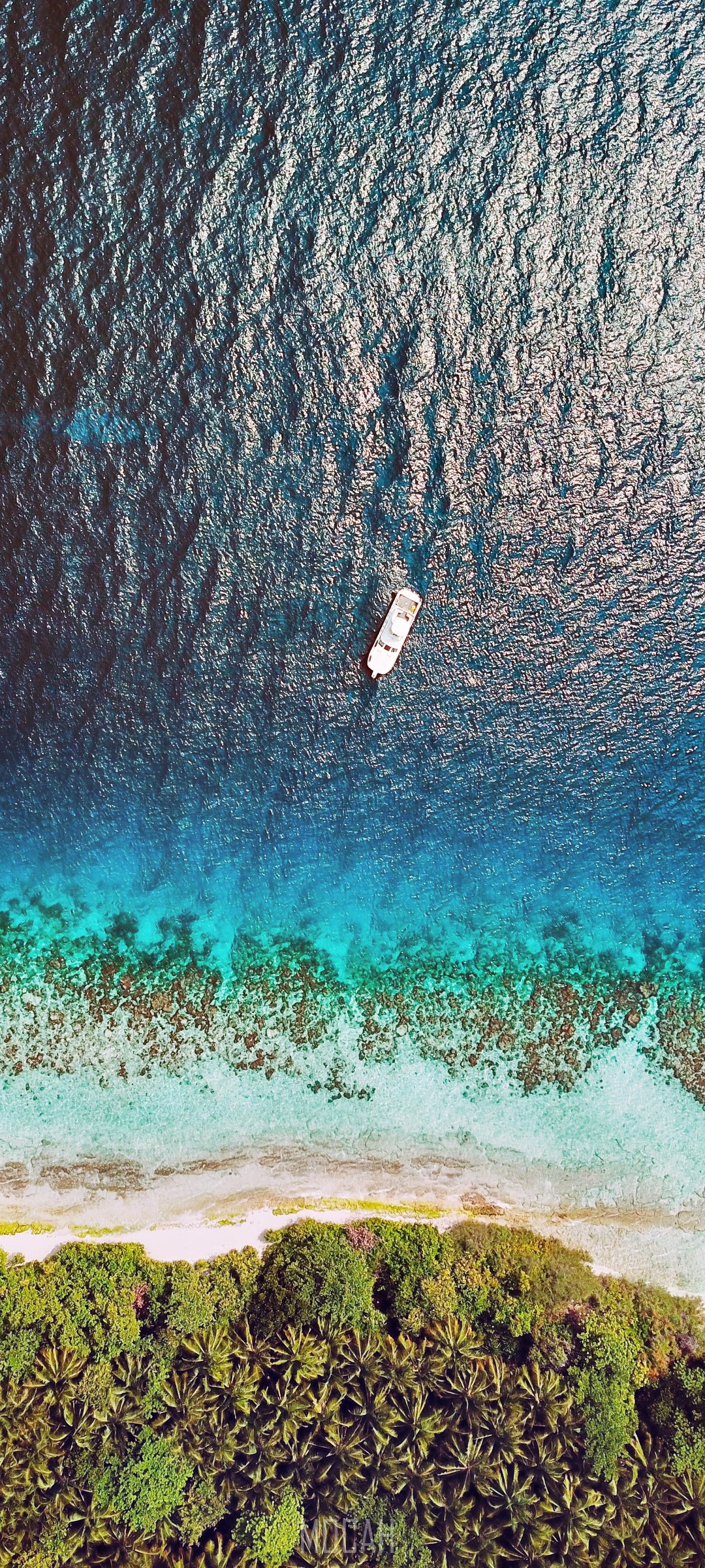 Aerial view of a boat near a tropical island HD Phone Wallpaper