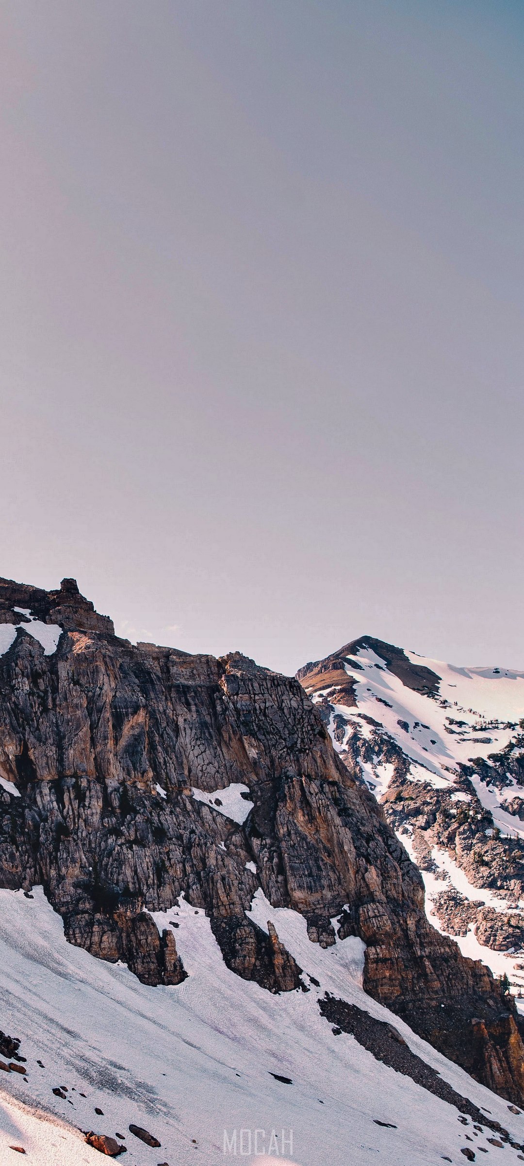Craggy rock towers on a snowy mountain slope HD Phone Wallpaper