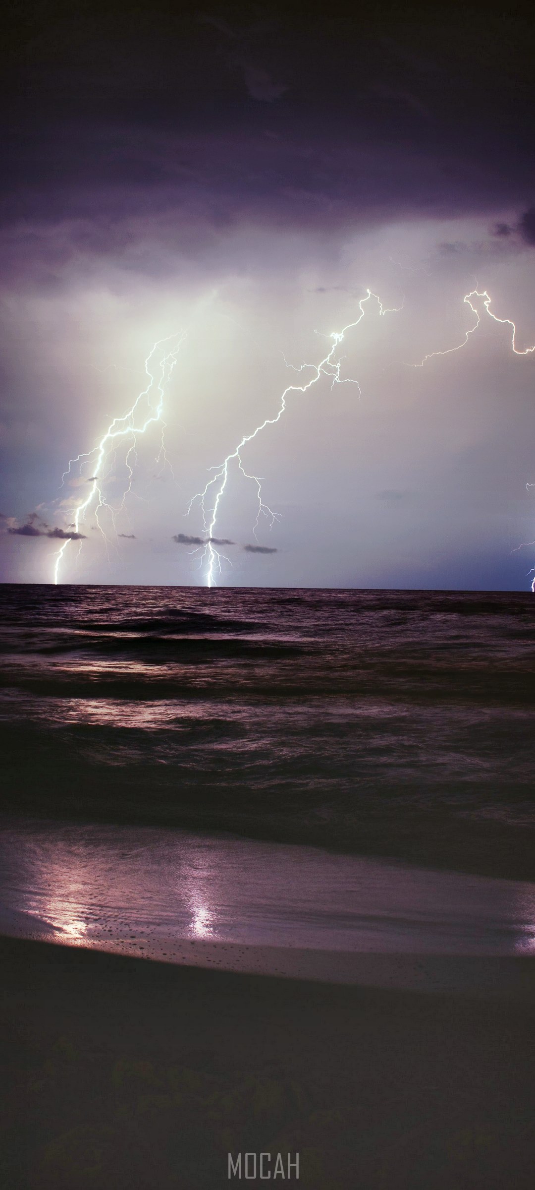 Lightning strikes over the ocean during a storm HD Phone Wallpaper