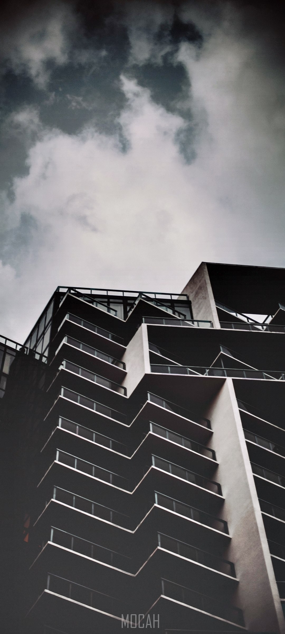 Modern building with zigzag balconies against cloudy sky HD Phone Wallpaper